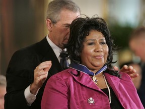 FILE - In this Nov. 9, 2005 file photo, President George W. Bush awards singer Aretha Franklin the Presidential Medal of Freedom Award, the highest civilian award, in the East Room of the White House in Washington. A person close to Franklin said on Monday that the 76-year-old singer is ill. Franklin canceled planned concerts earlier this year after she was ordered by her doctor to stay off the road and rest up.