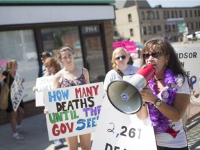 Lisa Whitehead leads a protest advocating for a safe injection site outside a proposed location on International Overdose Awareness Day, Friday, Aug. 31, 2018.