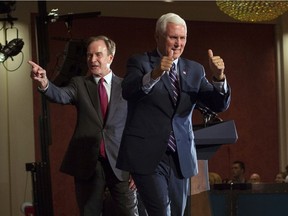 Republican gubernatorial candidate Bill Schuette and Vice President Mike Pence stand together after a GOP unity rally at the Amway Grand Plaza Hotel in Grand Rapids, Mich. Aug. 8, 2018.