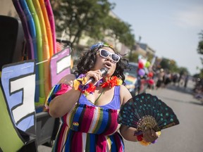 Connie Day amps up the crowd as the annual Windsor-Essex Pride Festival parade makes its way down Ottawa Street on Aug. 12, 2018.