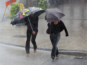 Showers send people scrambling in downtown Windsor on Thursday, July 18, 2013. A brief storm rolled through in the early afternoon dropping massive amounts of rain and lightning.