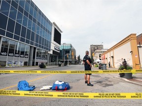 Windsor police officers  investigate the scene of a shooting at the intersection of University Avenue and Ouellette Avenue on the morning of Aug. 27, 2018.