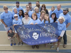 Mary Slavik, centre, is surrounded by friends and family of the late Jerry Slavik at Alumni Field on Aug. 24, 2018.  Jerry's Friends, an event to tribute Slavik, is being held at Alumni Field Saturday evening.