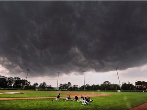 Aug. 6 — Members of the Tecumseh Thunder baseball team are shown at the Cullen Stadium field at Mic Mac Park on Monday, August 6, 2018, as threatening storm clouds quickly rolled in.