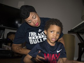 Zayvion Brooks, 4, is held by his mother Kiomi Boykin on July 31, 2018, in Windsor. Zayvion has autism and is undergoing chemotherapy treatments for leukemia.