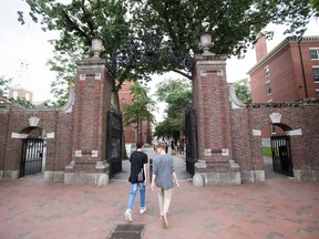 Pedestrians walk into the Harvard Yard at Harvard University on Aug. 30, 2018 in Cambridge, Massachusetts.