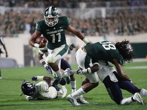 Connor Heyward of the Michigan State Spartans scores a third quarter touchdown while playing the Utah State Aggies at Spartan Stadium on August 31, 2018 in East Lansing, Michigan. Michigan State won the game 38-31.