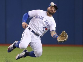 Kevin Pillar #11 of the Toronto Blue Jays makes a sliding catch in the eighth inning during MLB game action against the Houston Astros at Rogers Centre on Sept. 24, 2018, in Toronto.