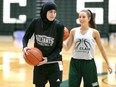 Windsor, Ontario.  September 12, 2018.  Saints Noor Bazzi, left, during practice with teammate Anna Ulicny at St. Clair College SportsPlex September 12, 2018. Bazzi will be playing varsity basketball with St. Clair College and she is the first player in Saints history to wear a hijab and to be fully covered on the hardwood. (NICK BRANCACCIO/Windsor Star).