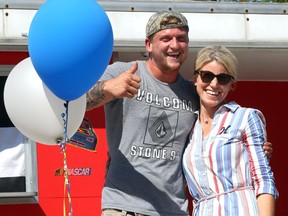 Testimonial speaker Jordan Blonde, left, a recovering addict, gives a thumbs up to some of his peers and Recovery Day visitors at Lanspeary Park September 15, 2018. Recovery Day emcee Fiona MacDonald, right, introduced and thanked Blonde for his contrite and inspiring speech.