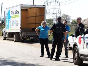 Habitat for Humanity Executive Director Fiona Coughlin, left, speaks with Windsor Police after their $100,000 Hino 22-foot delivery truck was recovered Russell Street in Windsor's West end on Sept. 15, 2018. The 2018 Hino truck was stolen and $40,000 in tools are still missing.
