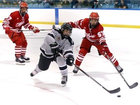 LaSalle, Ontario.  September 19, 2018.  On his backhand, LaSalle Vipers Jack Bowler shoots and scores against Leamington Flyers defenders Zach Taylor, right, and Ryan Gagnier, left, in first period Junior B hockey from Vollmer Recreation Complex September 19, 2018. (NICK BRANCACCIO/Windsor Star).  vipers flyers