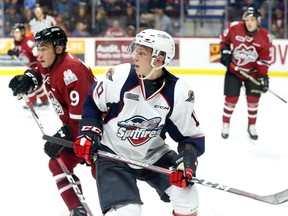 Windsor Spitfires Igor Larionov, front, and Guelph Storm Barret Kirwin, left, in OHL first period action from WFCU Centre Sept. 12, 2018.