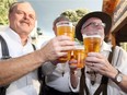 Rick Gruber, left, Joe Novosad, behind, and Frank Hauser, right, enjoy authentic Paulaner brew during Oktoberfest at Heimat Banquet Centre and Biergarten located on Drouillard Road Friday Sept. 28, 2018.