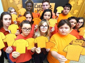 Walkerville high school students Katelynn Deavey, front left, Makenna Pickersgill, Emma Chlumecky and Alexa Moores pose with teachers and students Friday during Orange Shirt Day to honour the legacy of residential school victims and survivors. Students in the Contemporary First-Nations, Metis and Inuit Voices class also wrote out and posted accounts of indigenous children from residental schools. The orange shirts — from a story of one former student who recalled having her new orange shirt taken from her on the first day of school — is symbolic of losses in many First Nations communities.