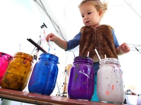 Young artist Luna Fantin, 2, dabs some blue paint at Art Lab display, part of Etsy Made in Canada event held at Canadian Historical Aircraft Museum September 29, 2018.