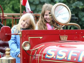 Kate MacPherson, 3, and Ava Robson, 9, in the driver's seat of a 1926 REO Speed Wagon pumper owned by Sandwich South Fire Fighters Association.  The vintage firetruck has a Bickle fire apparatus and was on display Sunday at the new Sandwich South Cultural and Resource Centre on Walker Road in Tecumseh.
