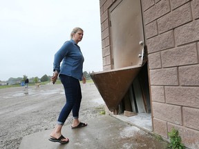 Sandra Garofalo on Monday shows the clubhouse door that was pried open during a burglary.