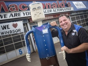 Larger than life. Peter Solly, owner of MacDonald's Automotive Supercentre, stands Sept. 27, 2018, next to his sculpture of the late Mark Boscariol, his latest in sculptures made from scrap metal parts. The two men were best friends for decades.