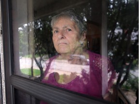 Blodwen Reitz looks out of her front door window on Sept. 13, 2018 at her downtown Windsor residence. With so many homeless people around her home she sometimes feels like a prisoner inside her house.