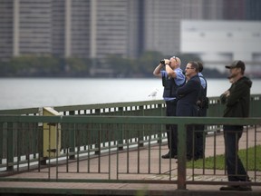 Authorities use binoculars as they monitor a situation on the Ambassador Bridge that left both directions of traffic closed for over an hour on the morning of Sept. 24, 2018.