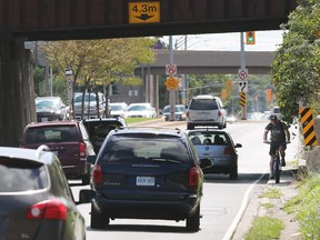 Tight squeeze. With the railway operator seemingly now on board, Windsor might be closer to a solution for the so-called Dougall 'death trap.' Here, a cyclist navigates the narrow path under the railway viaduct on Dougall Avenue on Sept. 11, 2018.