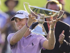 FILE - In this Sept. 24, 2017, file photo, Justin Thomas holds the trophy after winning the Fedex Cup after the Tour Championship golf tournament at East Lake Golf Club in Atlanta. The bonus pool for the PGA Tour season doubles next year to $70 million in a revamped system that pays $15 million to the FedEx Cup champion.