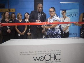 Coun. John Elliott, left, and longtime client, Patricia Grayer, cut the ribbon for the official opening of the Windsor Essex Community Health Centre in West Windsor, Tuesday, Sept. 25, 2018.