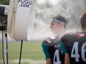 Nikko Hrcan, a player with the Essex County Ravens football team, tries to cool off during a junior varsity game at Windsor's Alumni Field in this June 2018 file photo.