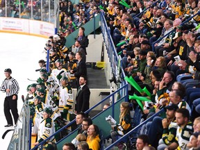 Humboldt Broncos players, new coach Nathan Oystrick and fans look on during second period SJHL hockey action against the Nipawin Hawks in Humbolt, Sask., on Sept. 12, 2018.