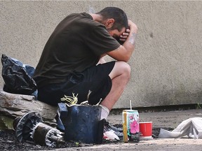 A homeless man sits across the street from the Salvation Army on Park Street West on Wednesday June 27, 2018 in Windsor. A local group is looking to address homelessness and mental health issues in the community.