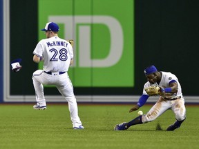 Blue Jays right fielder Billy McKinney (28) and centre fielder Jonathan Davis (right) collide while chasing down a hit by Astros' Josh Reddick during sixth inning MLB action in Toronto, Tuesday, Sept. 25, 2018.