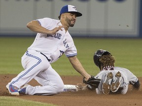 Cleveland Indians' Jose Ramirez is tagged out by Blue Jays second baseman Devon Travis in Toronto on Thursday, September 6, 2018. (THE CANADIAN PRESS/Fred Thornhill)