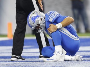 Detroit Lions quarterback Matthew Stafford holds his knee after a play against the New York Jets during the first half of an NFL football game in Detroit on Sept. 10, 2018.