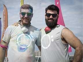 Peter Whitby, left, and Aaron McFerran wore their air-filtration masks at the seventh annual Color Run at Windsor's riverfront Festival Plaza on  Sept. 1, 2018.  Their company, O2 Canada, sells the masks around the world in countries with heavy air pollution.