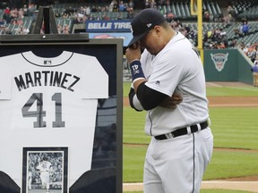 Detroit Tigers designated hitter Victor Martinez holds back tears during an on-field ceremony before the team's baseball game against the Kansas City Royals on Saturday, Sept. 22, 2018, in Detroit. Martinez, playing in his final game, has said he wants his final at-bats to be in front of the home fans.