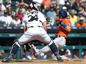 Houston Astros' Alex Bregman (2) scores at home plate as Detroit Tigers catcher James McCann (34) waits for the throw in the fifth inning of a baseball game in Detroit, Wednesday, Sept. 12, 2018.