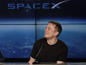 FILE - In this Feb. 6, 2018 file photo, Elon Musk, founder, CEO, and lead designer of SpaceX, speaks at a news conference after the Falcon 9 SpaceX heavy rocket launched successfully from the Kennedy Space Center in Cape Canaveral, Fla. SpaceX says it's signed the first private moon traveler. The big reveal on who it is _ and when the flight to the moon will be _ is scheduled for Monday, Sept. 17, 2018.
