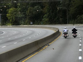 FILE- In this Sept. 26, 2015, file photo Philadelphia motorcycle police ride down a closed Schuylkill Expressway in Philadelphia. A federal safety agency is recommending that all new motorcycles built for road use in the U.S. have anti-lock brakes and electronic stability control as standard equipment. The National Transportation Safety Board says that while the technology is required on passenger cars, it has lagged for motorcycles.