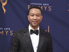 FILE - In this Sept. 9, 2018 file photo, John Legend arrives at the Creative Arts Emmy Awards in Los Angeles. Legend will become a coach on NBC's "The Voice."