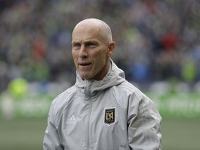 In this March 4, 2018 photo Los Angeles head coach Bob Bradley walks on the pitch before an MLS soccer match against the Seattle Sounders in Seattle. Probably the most prominent of the "new" coaches this season is MLS vet Bob Bradley, who has the expansion Los Angeles FC in the playoff picture with seven games remaining.