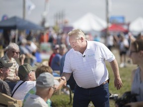 Ontario Premier Doug Ford meets with people attending the 2018 International Plowing Match and Rural Expo in Pain Court outside Chatham, Tuesday, Sept. 18, 2018.