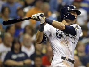 Milwaukee Brewers' Christian Yelich hits a two-run home run during the fifth inning of a baseball game against the Cincinnati Reds Sept. 17, 2018, in Milwaukee.