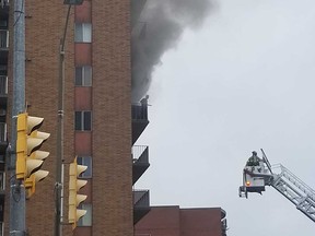 Windsor firefighters move in on an aerial platform to rescue a man from the balcony of his smoke-filled apartment at 1666 Ouellette Ave. on Sept. 6, 2018, in this reader-submitted photo.