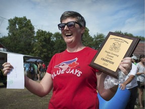 Sarah Laferte holds the plaque and envelope containing $15 she won for winning the people crowing contest at the Harrow Fair on Sept. 1, 2018. Laferte did the best impression of a rooster crow in the competition.