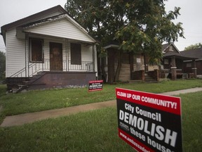 Bridge company signs urging city council to demolish vacant buildings owned by Matty Moroun, are pictured on Edison Street in West Windsor on Sept. 10, 2018.