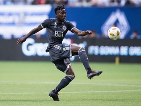 Vancouver Whitecaps' Alphonso Davies loses his balance and falls to the ground after taking control of the ball against the San Jose Earthquakes during the first half of an MLS soccer game in Vancouver on Sept. 1, 2018.