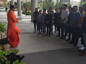 Hindu priest Paresh Pandya addresses mourners at a vigil held outside Windsor city hall on Sept. 21, 2018, for a former St. Clair College student.