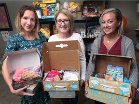 Lisa Homenick, left, Danielle Moldovan, centre, and Michelle VandenBrink display their "Fun-In-The-Box" gift pack on Monday, September 24, 2018. The three Amherstburg mothers started the online business that ships boxes full of toys to kids.