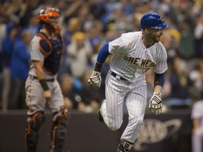 Milwaukee Brewers' Ryan Braun hits a two-run RBI double against the Detroit Tigers during the seventh inning of an baseball game Sunday, Sept. 30, 2018, in Milwaukee.